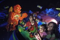Guests shoot the aliens on the Buzz Ligtyear Space Ranger spin ride at the Magic Kingdom.